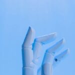 Ai Future - Robot's Hand on Blue Background