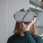 Innovation Redefined - woman in black sweater holding white and black vr goggles